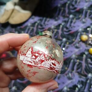 vintage glass Christmas ornament stenciled children  gifts  silver background.